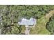 Single story home with metal roof, large backyard, and paved patio at 6902 E 29Th Ave, Tampa, FL 33619