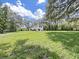 Spacious backyard with a house and lush greenery at 6902 E 29Th Ave, Tampa, FL 33619