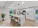 Modern kitchen with white shaker cabinets, marble countertops, and stainless steel appliances at 6902 E 29Th Ave, Tampa, FL 33619