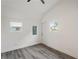 Bright bonus room features grey flooring, a door, and two windows at 2395 19Th St, Sarasota, FL 34234