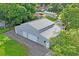 Aerial view of a gray barn-style building with three garage doors and a gravel driveway at 2395 19Th St, Sarasota, FL 34234