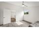 Upstairs bedroom with gray flooring, a ceiling fan and access to another room at 2395 19Th St, Sarasota, FL 34234
