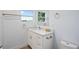 Modern bathroom with white vanity, quartz countertop, and toilet at 2395 19Th St, Sarasota, FL 34234