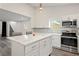 Modern kitchen with white cabinets, quartz countertops, and stainless steel appliances at 2395 19Th St, Sarasota, FL 34234