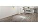 Modern kitchen with island, gray vinyl plank flooring, and white cabinets at 2395 19Th St, Sarasota, FL 34234