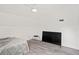 Large bedroom with gray flooring, a ceiling fan, and a large TV at 2395 19Th St, Sarasota, FL 34234