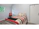 Cozy bedroom with a striped comforter and window at 2395 19Th St, Sarasota, FL 34234