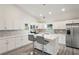 Modern kitchen with white cabinets, quartz countertops and island at 2395 19Th St, Sarasota, FL 34234