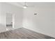 Bright bedroom featuring gray vinyl plank flooring and ceiling fan at 2395 19Th St, Sarasota, FL 34234