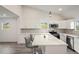 Modern kitchen with white cabinets, quartz countertops and breakfast bar at 2395 19Th St, Sarasota, FL 34234