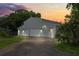 Gray barn-style building with three garage doors, offering ample storage at 2395 19Th St, Sarasota, FL 34234