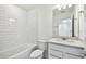 This bathroom has a white vanity, a tub with white subway tile surround, and modern fixtures at 1268 Kazaz Ct, Zephyrhills, FL 33540
