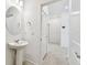 A white vanity with a vessel sink is accented by modern fixtures and lighting at 1268 Kazaz Ct, Zephyrhills, FL 33540