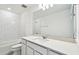 A bright bathroom features a white vanity with a tub and shower combo at 1268 Kazaz Ct, Zephyrhills, FL 33540