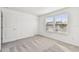 This carpeted bedroom features a door leading to the hallway and two windows at 1268 Kazaz Ct, Zephyrhills, FL 33540