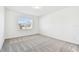 Clean bedroom with neutral walls, carpeted floors, and a window providing natural light at 1268 Kazaz Ct, Zephyrhills, FL 33540