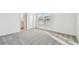 This bedroom features neutral carpet with a door leading to the bathroom at 1268 Kazaz Ct, Zephyrhills, FL 33540