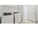 The laundry room includes a modern washer and dryer as well as convenient shelving at 1268 Kazaz Ct, Zephyrhills, FL 33540