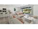 Bright living room featuring modern decor, open to the kitchen, and large windows offering outdoor views at 1268 Kazaz Ct, Zephyrhills, FL 33540