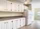 White kitchen with granite countertops and stainless steel appliances at 34051 Brown Byu, Wesley Chapel, FL 33543