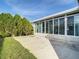 Private patio with adjacent sunroom and landscaping at 34051 Brown Byu, Wesley Chapel, FL 33543