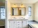 Bathroom with a double vanity and large mirrors at 34051 Brown Byu, Wesley Chapel, FL 33543
