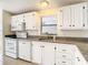White kitchen with granite countertops and stainless steel appliances at 34051 Brown Byu, Wesley Chapel, FL 33543