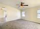 Spacious bedroom with carpet, window, and access to another room at 34051 Brown Byu, Wesley Chapel, FL 33543