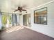 Bright sunroom with ceiling fan, carpet, and window curtains at 34051 Brown Byu, Wesley Chapel, FL 33543