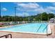 Inviting community pool with lounge chairs and a view of trees at 34051 Brown Byu, Wesley Chapel, FL 33543