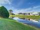 Mobile home with water view and lush green landscaping at 34051 Brown Byu, Wesley Chapel, FL 33543