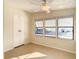 Bright bedroom with tile flooring, large windows, and a double door closet at 34051 Brown Byu, Wesley Chapel, FL 33543