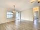 Bright dining room features wood-look floors and sliding glass doors leading to a screened porch at 34051 Brown Byu, Wesley Chapel, FL 33543