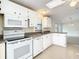 White kitchen with granite countertops and stainless steel appliances at 34051 Brown Byu, Wesley Chapel, FL 33543