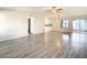 Spacious living room with light wood laminate flooring and sliding door access at 34051 Brown Byu, Wesley Chapel, FL 33543
