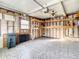 Unfinished garage with built-in shelving and pegboard at 34051 Brown Byu, Wesley Chapel, FL 33543