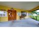 Community clubhouse entrance with wooden doors and a bench at 34051 Brown Byu, Wesley Chapel, FL 33543
