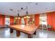 Community billiards room with a pool table and orange curtains at 34051 Brown Byu, Wesley Chapel, FL 33543