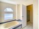 Bathroom with jetted bathtub, shower stall and window at 34051 Brown Byu, Wesley Chapel, FL 33543