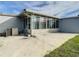 Concrete patio next to sunroom and AC unit at 34051 Brown Byu, Wesley Chapel, FL 33543
