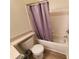 Updated bathroom with tub shower, toilet, and gray shower curtain at 5901 Brickleberry Ln # 101, Zephyrhills, FL 33541