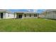 Large backyard with grassy area and covered patio at 18212 Hunters Meadow Walk, Land O Lakes, FL 34638