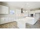 Modern kitchen with white cabinetry and a large center island at 10243 Surrey Rose Dr, San Antonio, FL 33576