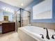 Bathroom with garden tub, walk-in shower and dual sinks at 32527 Harmony Oaks Dr, Wesley Chapel, FL 33545