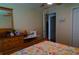 Bedroom with floral bedding and a sewing machine on a desk at 20006 Nob Oak Ave, Tampa, FL 33647