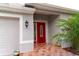 Inviting front entrance with red door and landscaping at 20006 Nob Oak Ave, Tampa, FL 33647