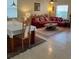 Combined dining and living room with a burgundy sofa at 20006 Nob Oak Ave, Tampa, FL 33647