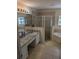 Primary bathroom with granite vanity, shower and bathtub at 20006 Nob Oak Ave, Tampa, FL 33647