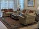 Spacious living room with beige leather furniture and a large area rug at 20006 Nob Oak Ave, Tampa, FL 33647
