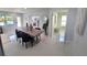 Bright dining area with a large wooden table and black chairs, looking toward the kitchen at 2305 W Clifton St, Tampa, FL 33603